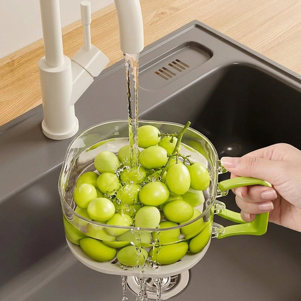 Dual-layer kitchen colander and strainer being rinsed under clean running water, showcasing functional sink-to-table design